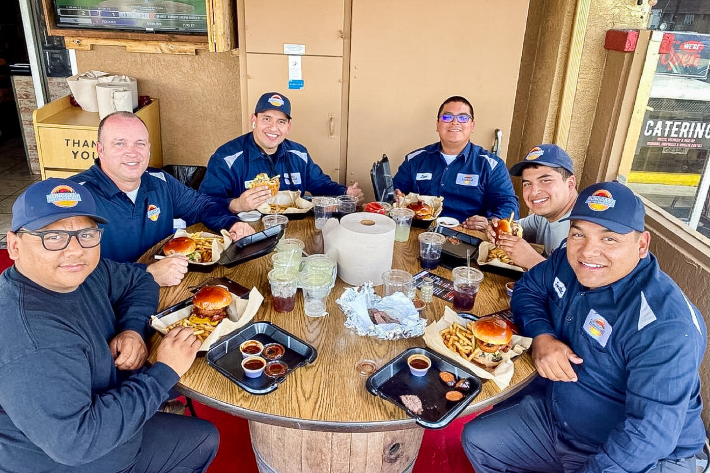 A company work team gathers at Corbin's Q to enjoy some tri tip sandwiches on their lunch break. 