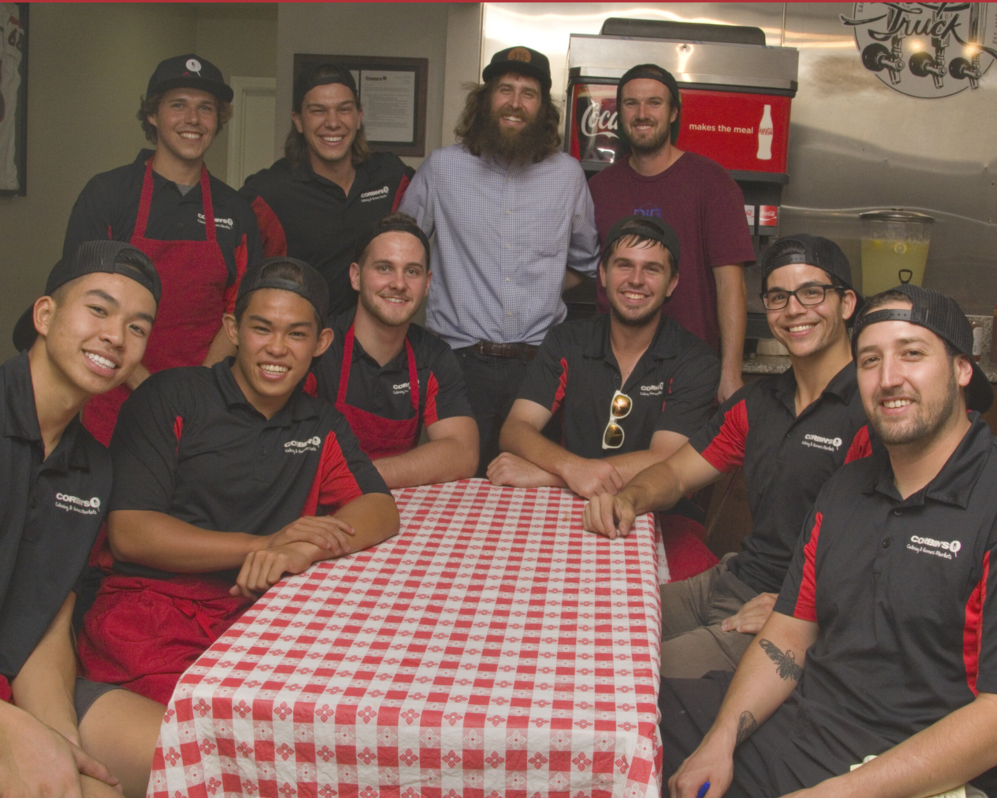 Corbin's Q bar and barbecue team gathers inside the restaurant after a long day of serving barbecue near San Diego State University. 